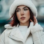 Elegant woman in winter attire posing outdoors in Istanbul, showcasing modern fashion trends.